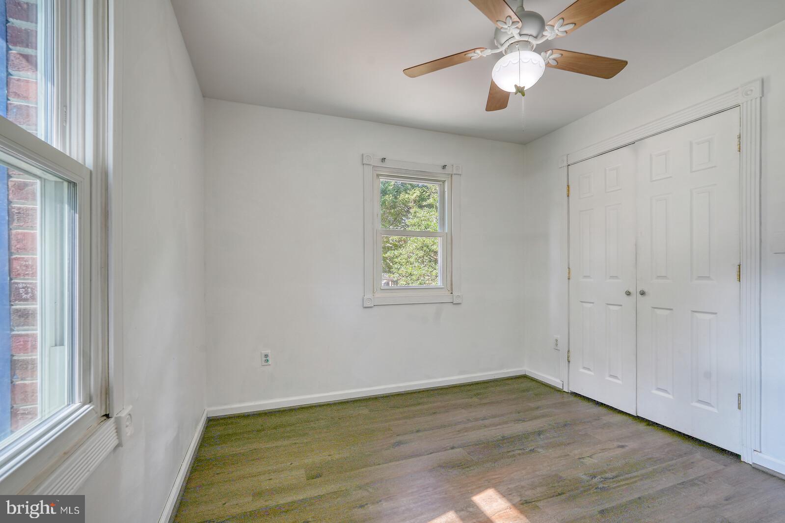 1142 Calvert Beach Road St. Leonard, MD 20685 - Photo 42 of 63 a view of an empty room with a window and wooden floor