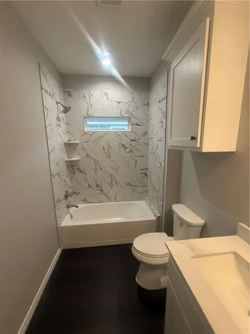 a bathroom with a sink a toilet and a bathtub