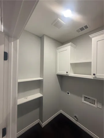 a view of storage and utility room with wooden floor