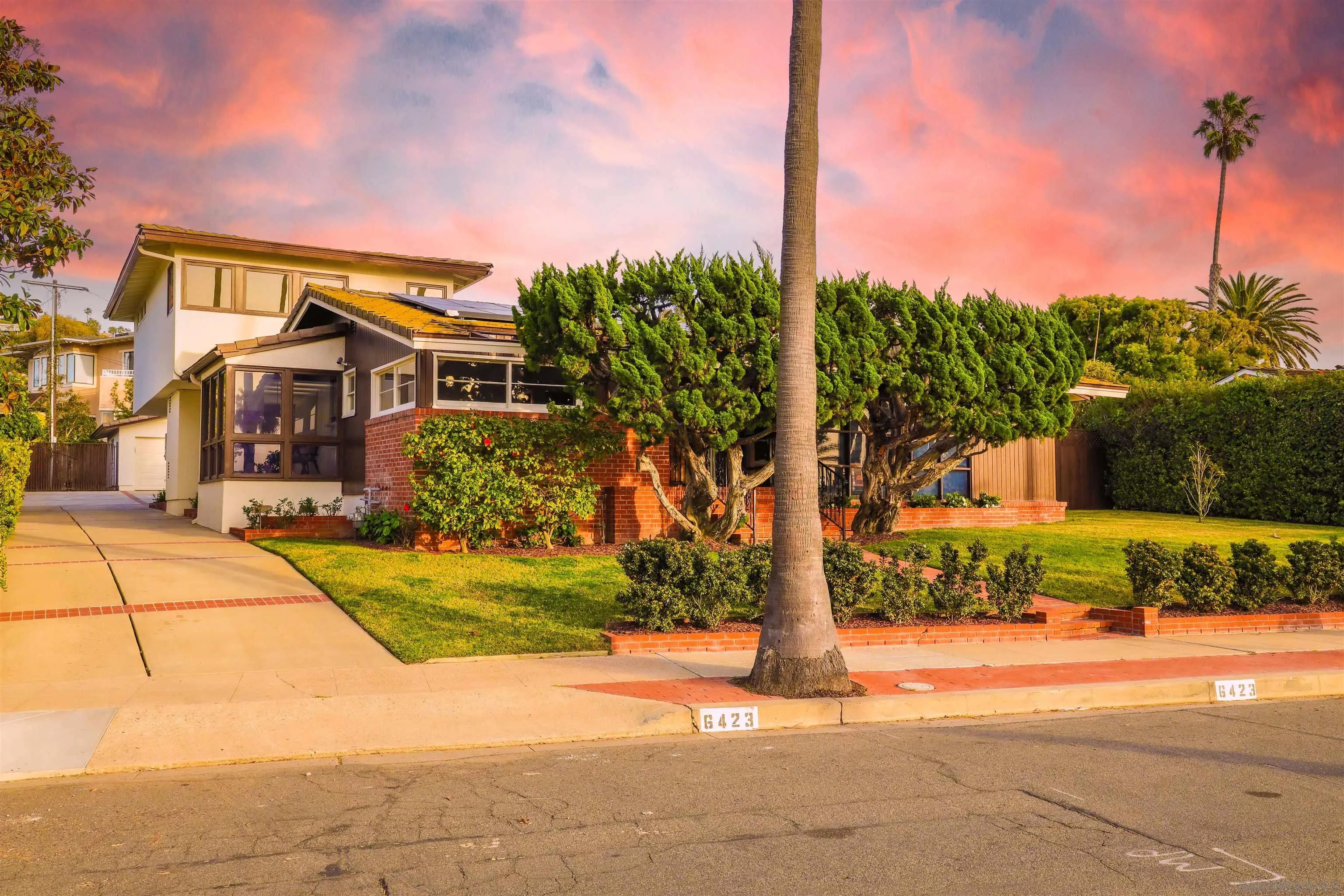 6423 Avenida Cresta La Jolla, CA 92037 - Photo 2 of 33 a front view of a house with a yard and trees