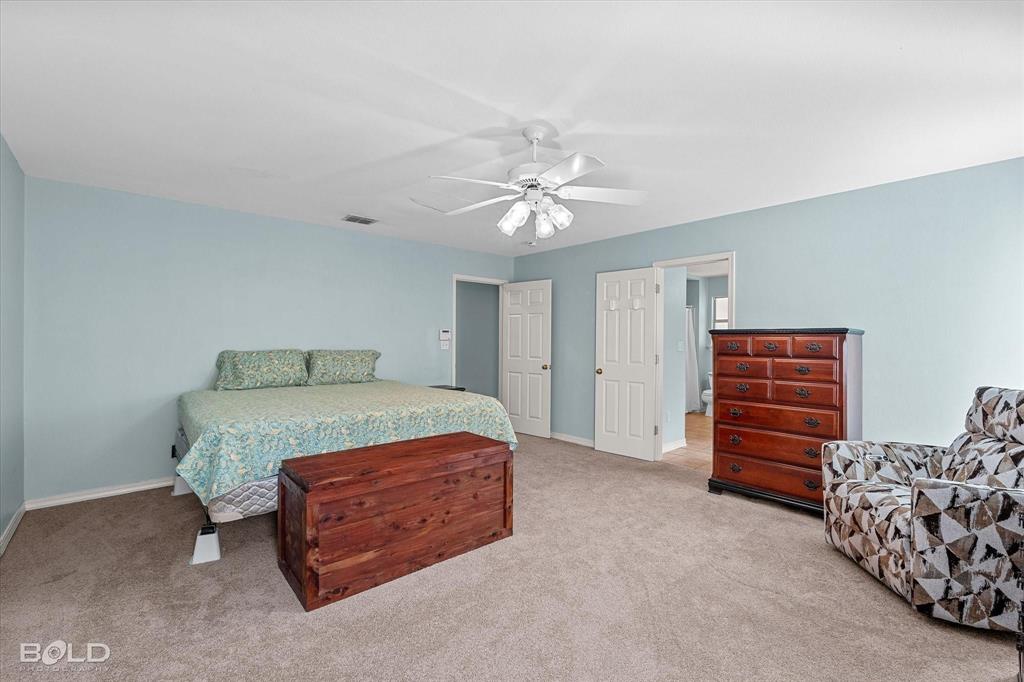 136 Scarborough Road Benton, LA 71006 - Photo 18 of 37 Light blue walls complement the neutral carpet flooring