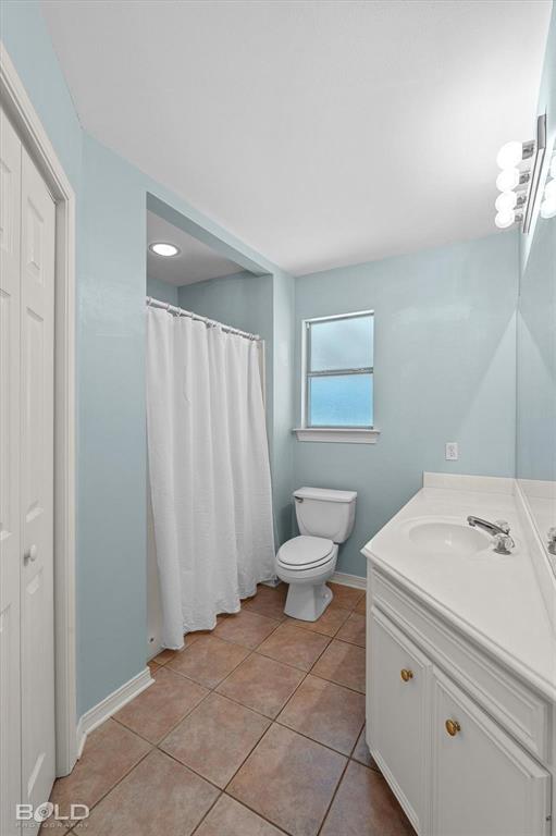 136 Scarborough Road Benton, LA 71006 - Photo 19 of 37 Bathroom featuring a single vanity with storage, tile flooring, a built-in shower, and a window