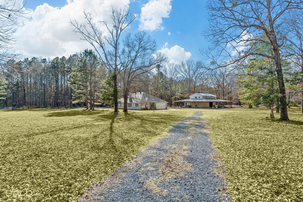 136 Scarborough Road Benton, LA 71006 - Photo 2 of 37 Expansive gravel driveway leading to two distinct structures