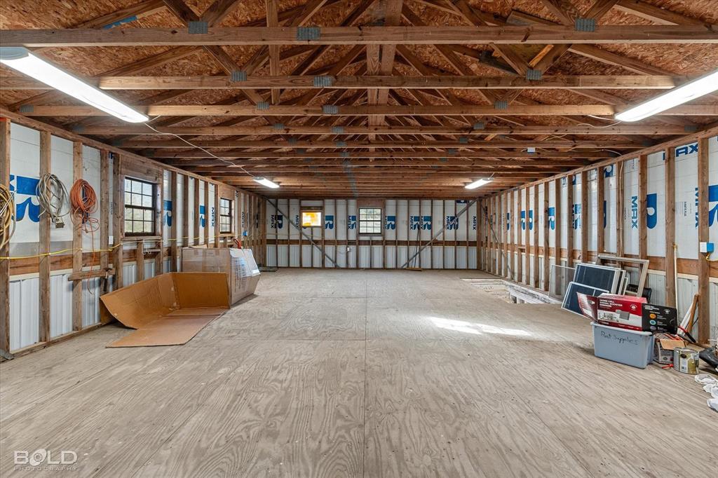 136 Scarborough Road Benton, LA 71006 - Photo 25 of 37 Spacious multi-purpose room featuring exposed wood beam ceilings and plywood flooring