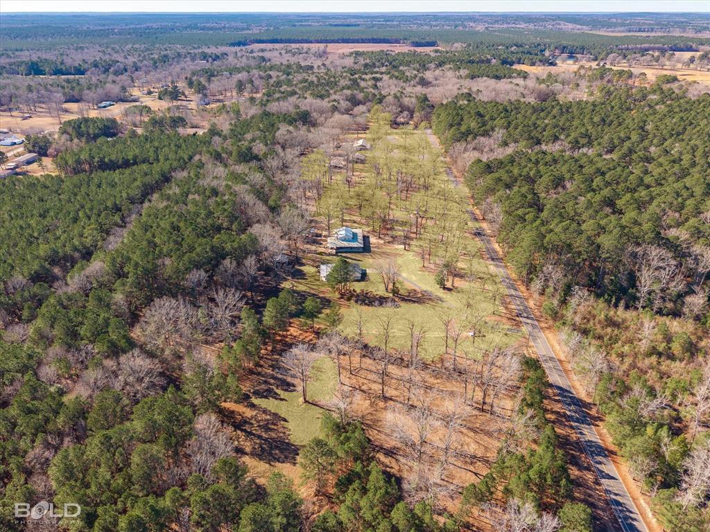 136 Scarborough Road Benton, LA 71006 - Photo 37 of 37 Expansive wooded parcel featuring a paved road frontage, multiple clearings, and existing structures amidst a dense tree line