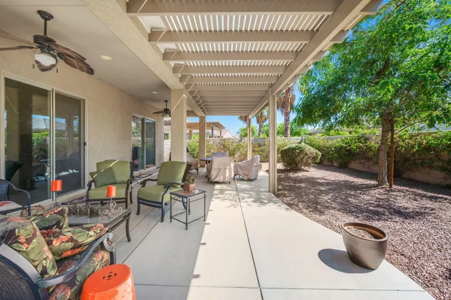 a view of a house with backyard and sitting area