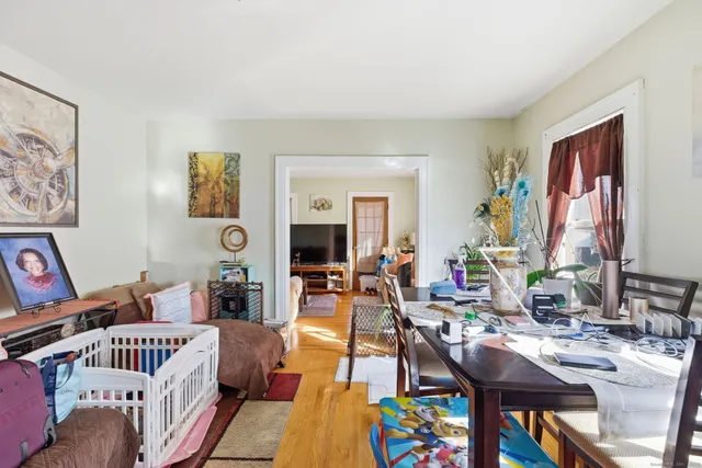 a living room with furniture and painting on the wall