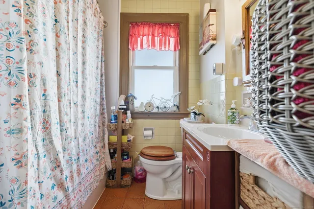 a bathroom with a sink a toilet and a window