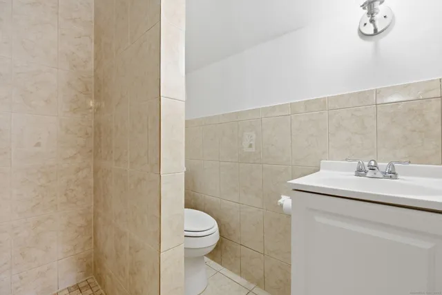 a bathroom with a sink a toilet and a shower