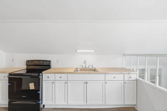 a kitchen with cabinets and window