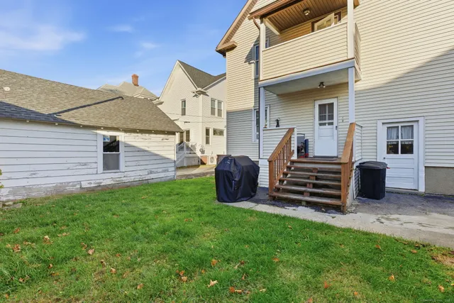 a view of a house with backyard porch and wooden fence