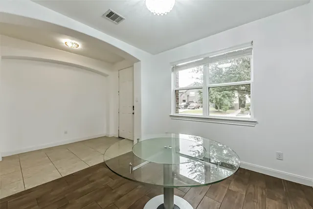 a living room with hard wood flooring