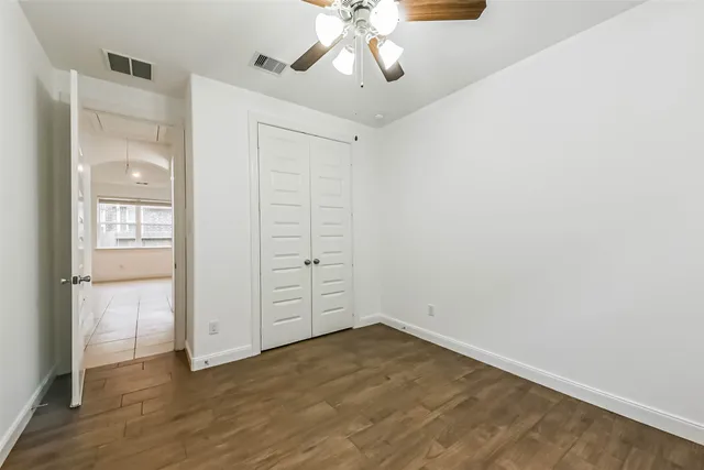 an empty room with cabinet and wooden floor
