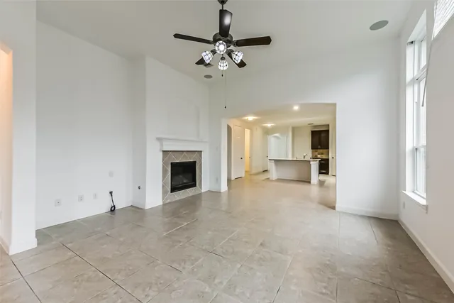 a view of a kitchen and a sink a fireplace window and a chandelier