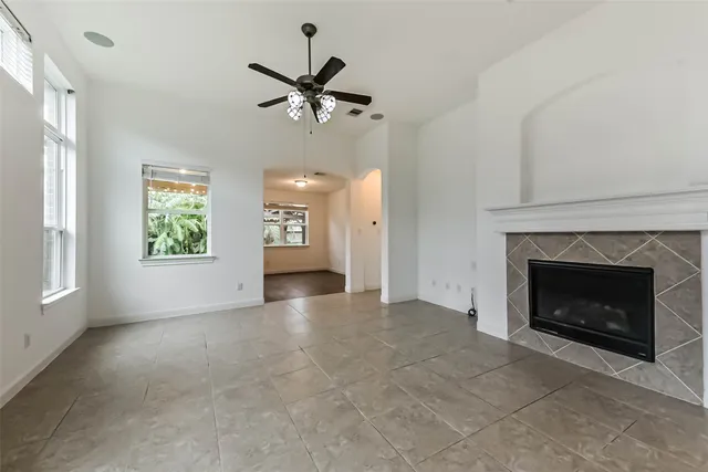 a view of an empty room with window and fire place