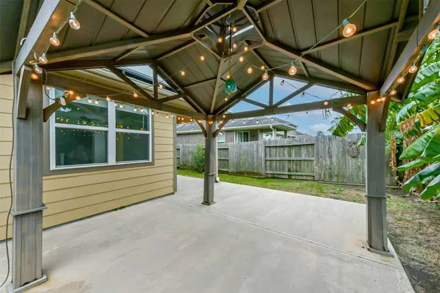 a view of a house with a small yard and floor to ceiling window
