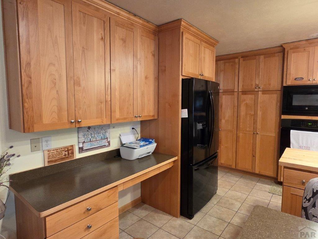 1000 Rittgers Street Eads, CO 81036 - Photo 11 of 33 a kitchen with a refrigerator and cabinets