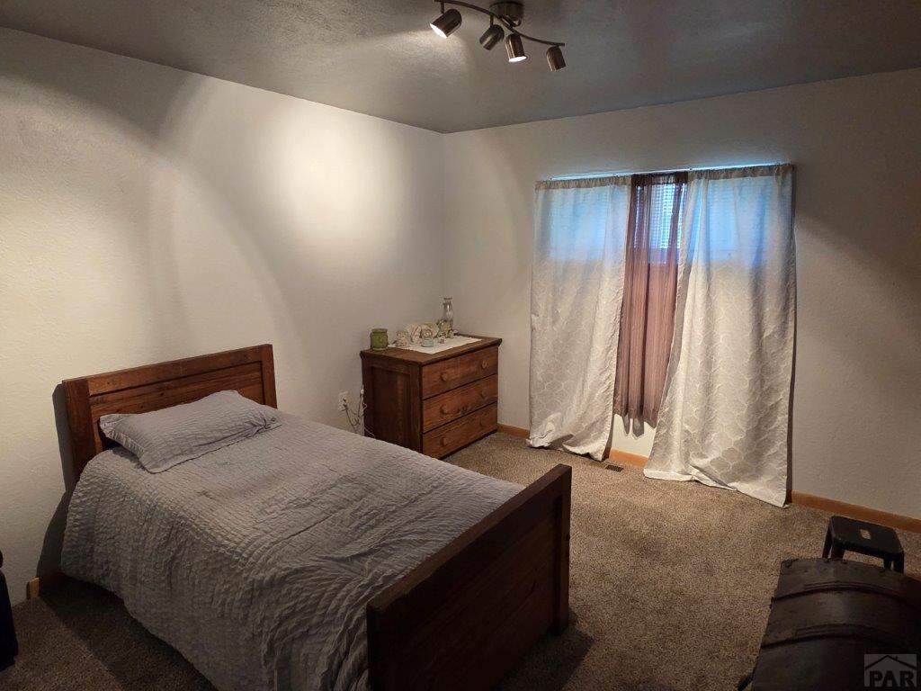 1000 Rittgers Street Eads, CO 81036 - Photo 18 of 33 a bedroom with a bed and a mirror