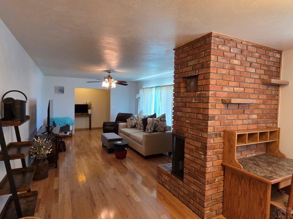 1000 Rittgers Street Eads, CO 81036 - Photo 6 of 33 a living room with furniture wooden floor and a fireplace