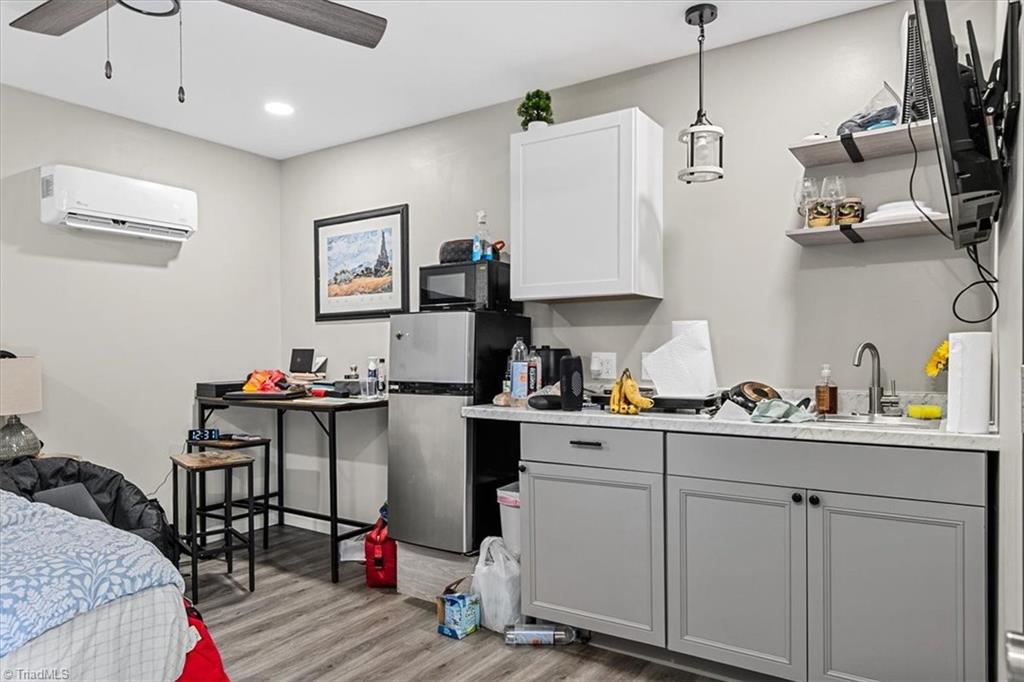 226 Friendly Avenue High Point, NC 27260 - Photo 18 of 38 A private kitchenette within the primary suite includes a mini refrigerator, microwave, and prep counter, giving the space true independence from the main kitchen. Please note this suite is unpermitted and full seller disclosures are available.