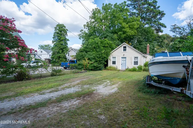 a view of a house with a yard and sitting area