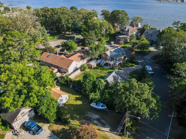 an aerial view of a house with yard swimming pool and outdoor seating