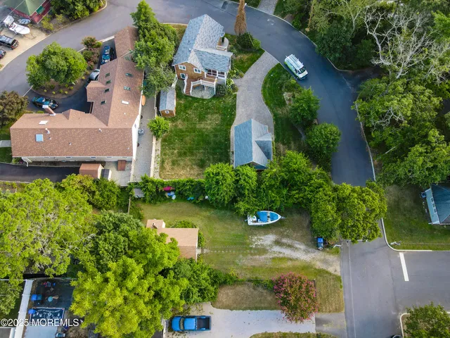 an aerial view of a house with garden space and a street view