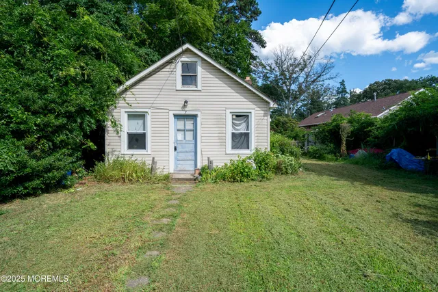a view of a house with yard and a garden