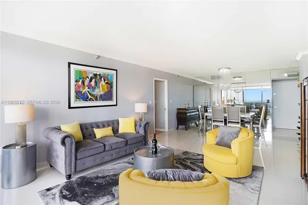 a living room with furniture and kitchen view