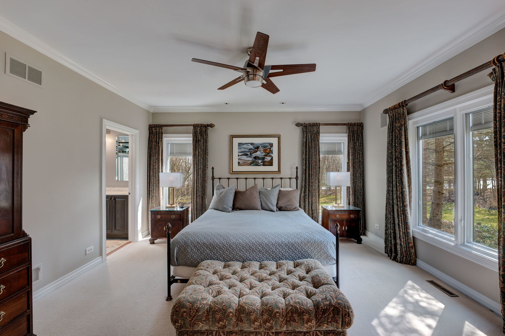 791 South Ridge Road Lake Forest, IL 60045 - Photo 18 of 40 a bedroom with a large bed and a chandelier fan