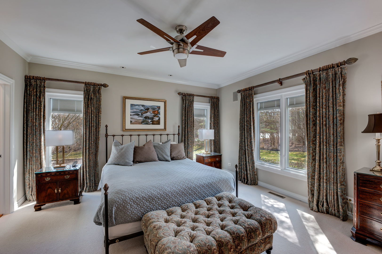 791 South Ridge Road Lake Forest, IL 60045 - Photo 19 of 40 a bedroom with a large bed and a chandelier fan