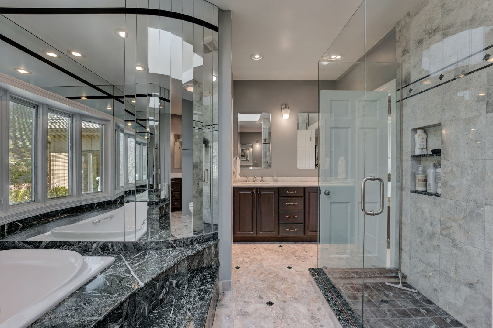 791 South Ridge Road Lake Forest, IL 60045 - Photo 24 of 40 a bathroom with a granite countertop sink a large mirror and shower