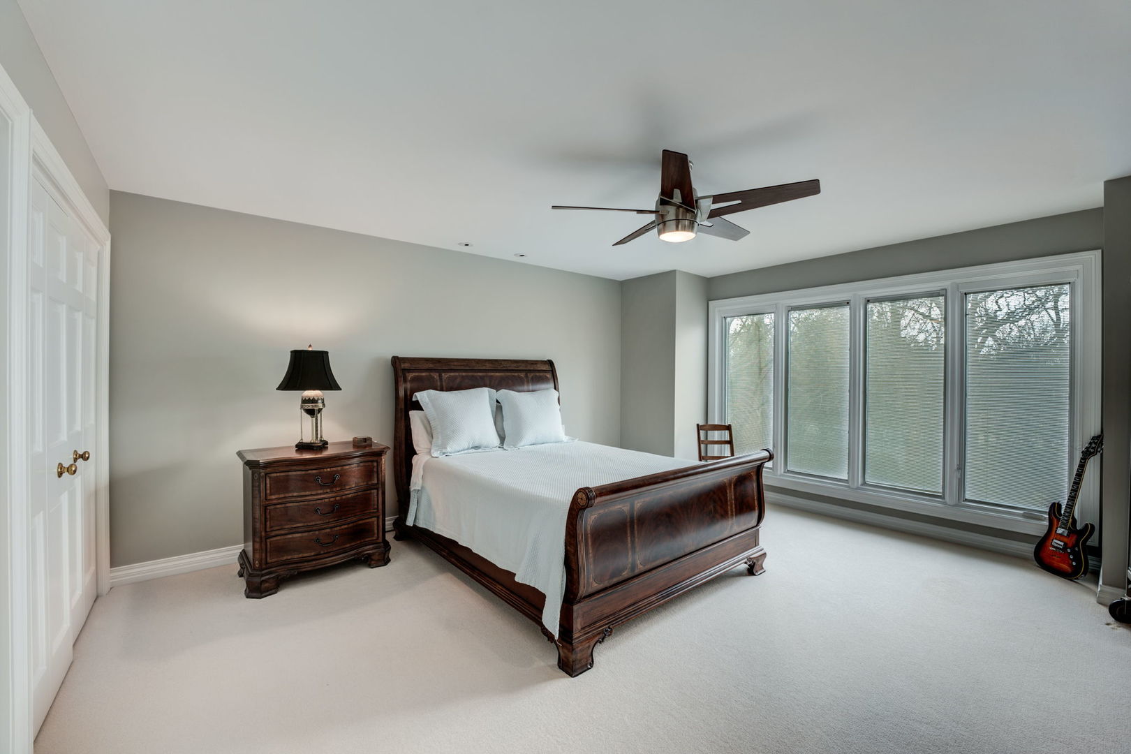 791 South Ridge Road Lake Forest, IL 60045 - Photo 25 of 40 a spacious bedroom with a bed and glass door