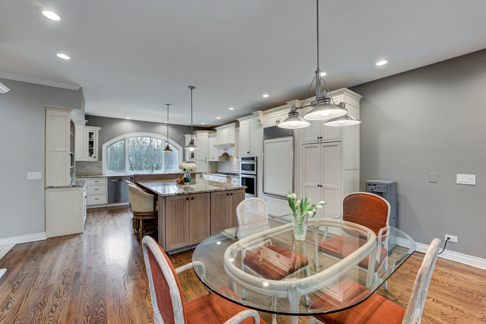 791 South Ridge Road Lake Forest, IL 60045 - Photo 10 of 40 a kitchen with kitchen island stainless steel appliances a dining table chairs sink and wooden floor
