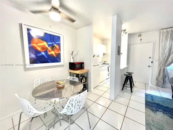 a living room with furniture a rug and a painting on the wall