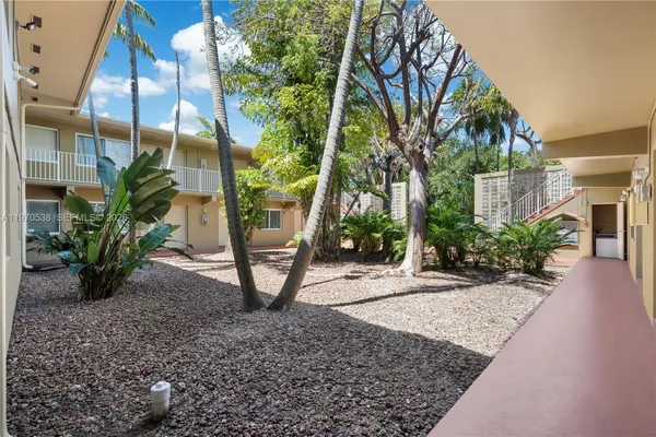 a view of a pathway both side of the house