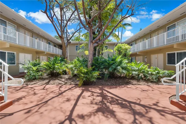 a view of a house with palm trees