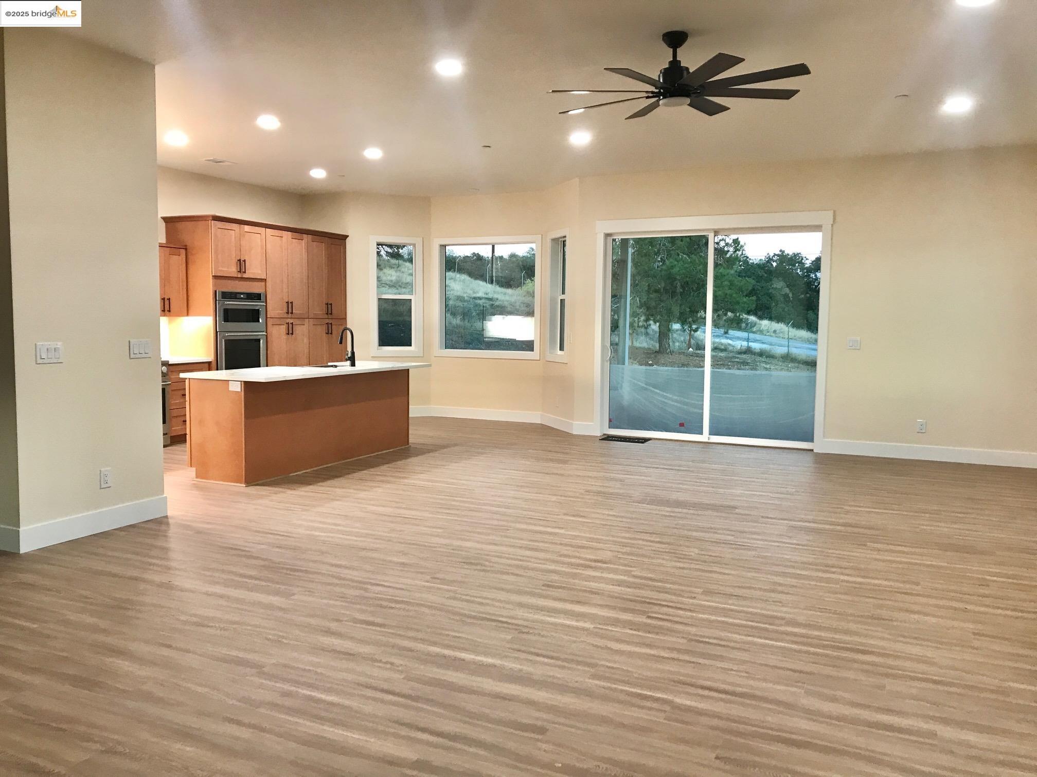 17500 Harvard Mine Road Jamestown, CA 95327 - Photo 37 of 37 Kitchen with brown cabinets, open floor plan, recessed lighting, and plenty of natural light