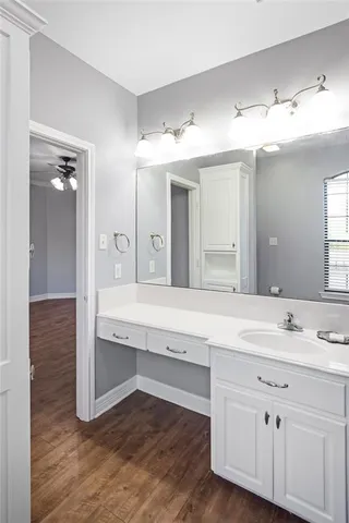 a bathroom with a sink double vanity granite and a mirror