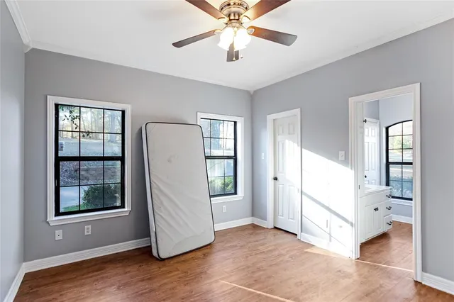 a view of a bedroom with closet and windows