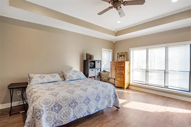 a bedroom with a large bed and a chandelier