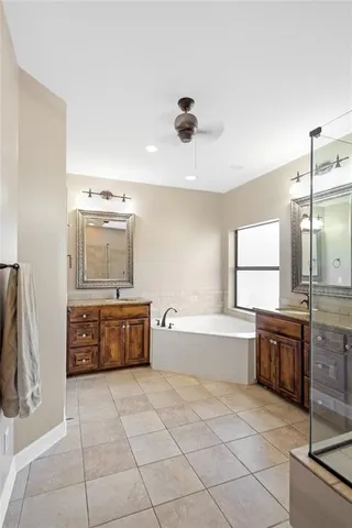 a large kitchen with a stove a refrigerator and a sink