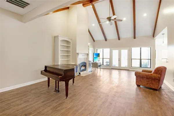a living room with furniture and a wooden floor