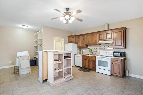 a kitchen with cabinets and chairs