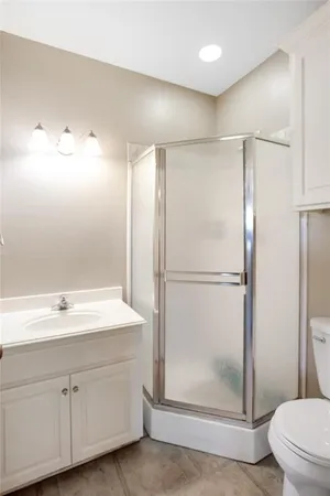 a bathroom with a shower sink and toilet