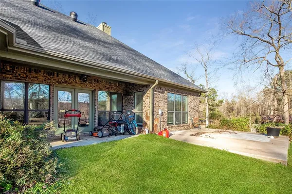 a man is sitting on a bench in front of a building