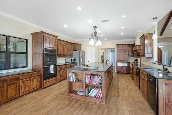 a large kitchen with lots of counter space and stainless steel appliances