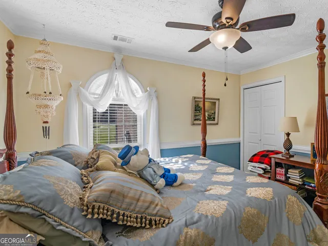 a bed room with a bed and a chandelier