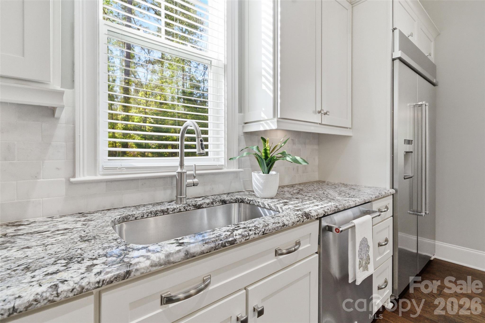3097 Sherman Drive Lancaster, SC 29720 - Photo 15 of 48 a kitchen with granite countertop a sink window and cabinets