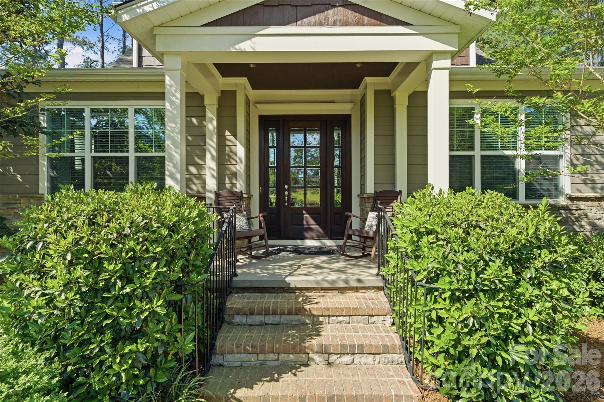 3097 Sherman Drive Lancaster, SC 29720 - Photo 3 of 48 a front view of a house with a large window and potted plants